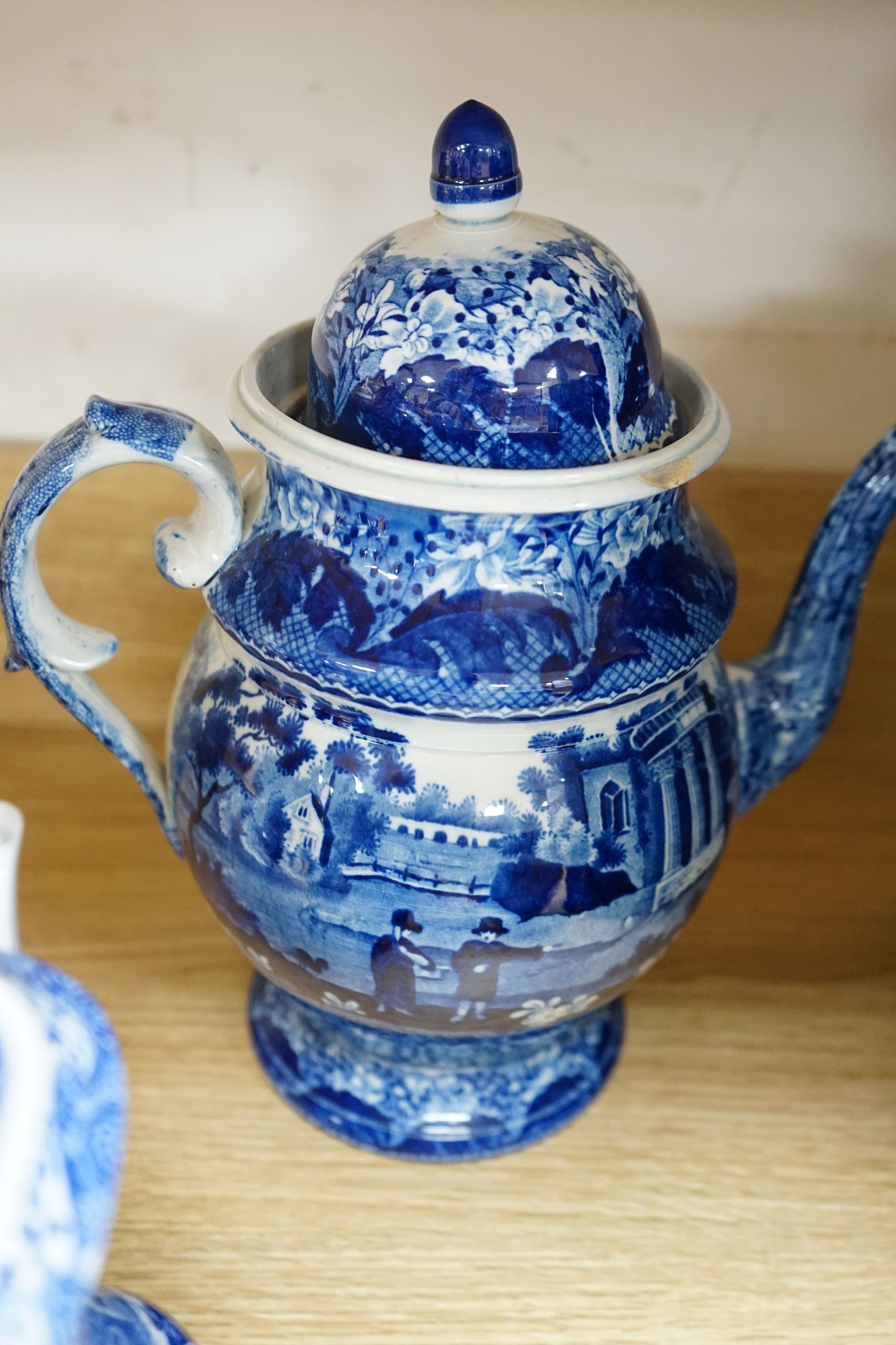 An early 19th century pearlware blue and white tea pot, two others and a Wedgwood style teapot, tallest 30cms high